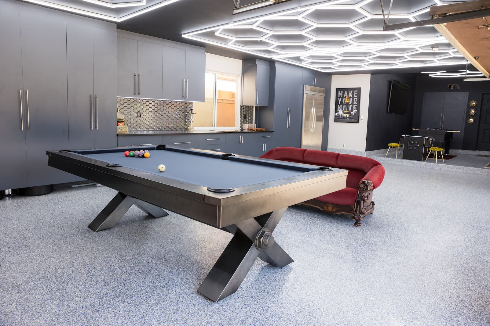 Finished garage space with epoxy flooring, custom cabinets, and multipurpose layout.