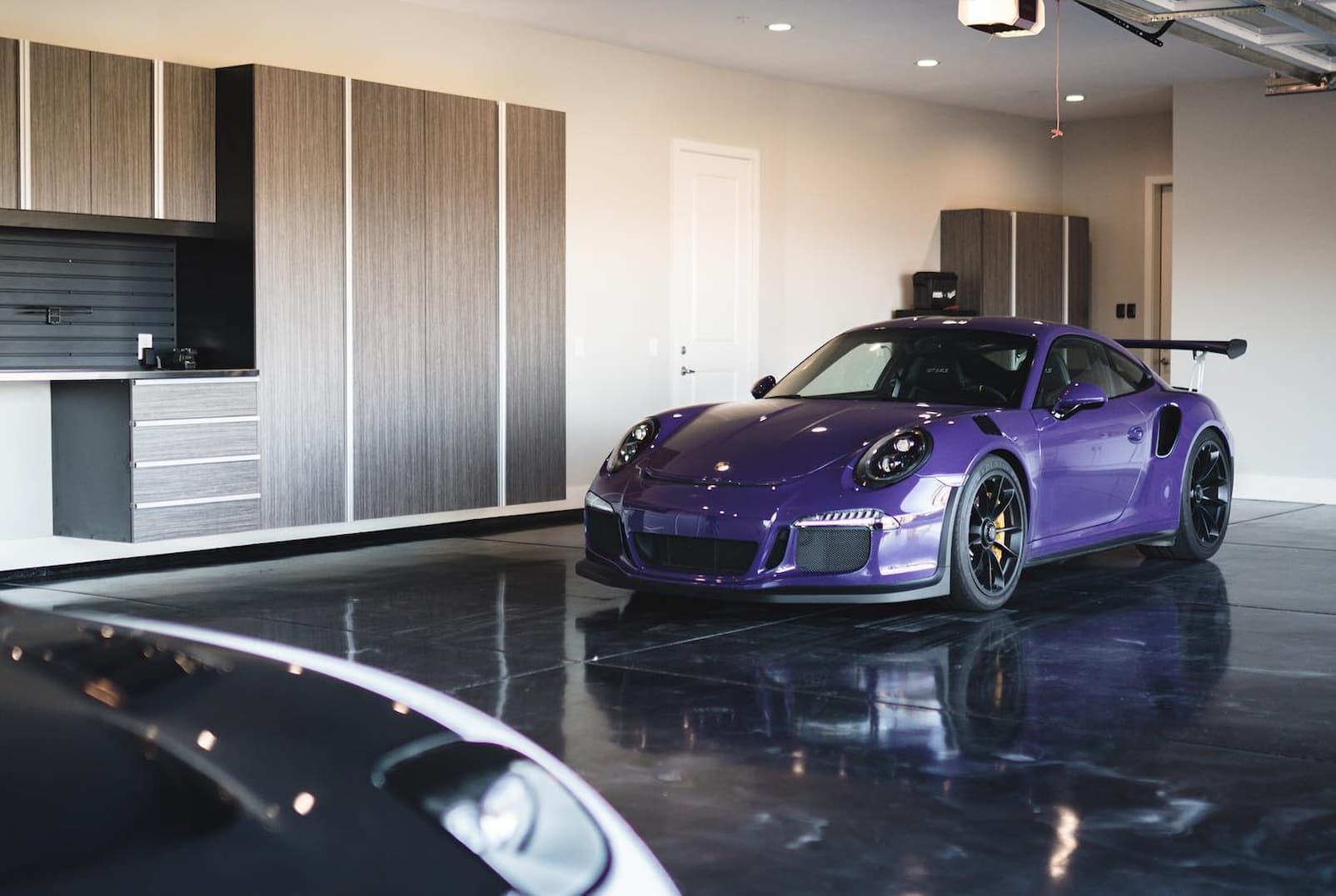 High-end garage design featuring luxury epoxy flooring and custom storage.