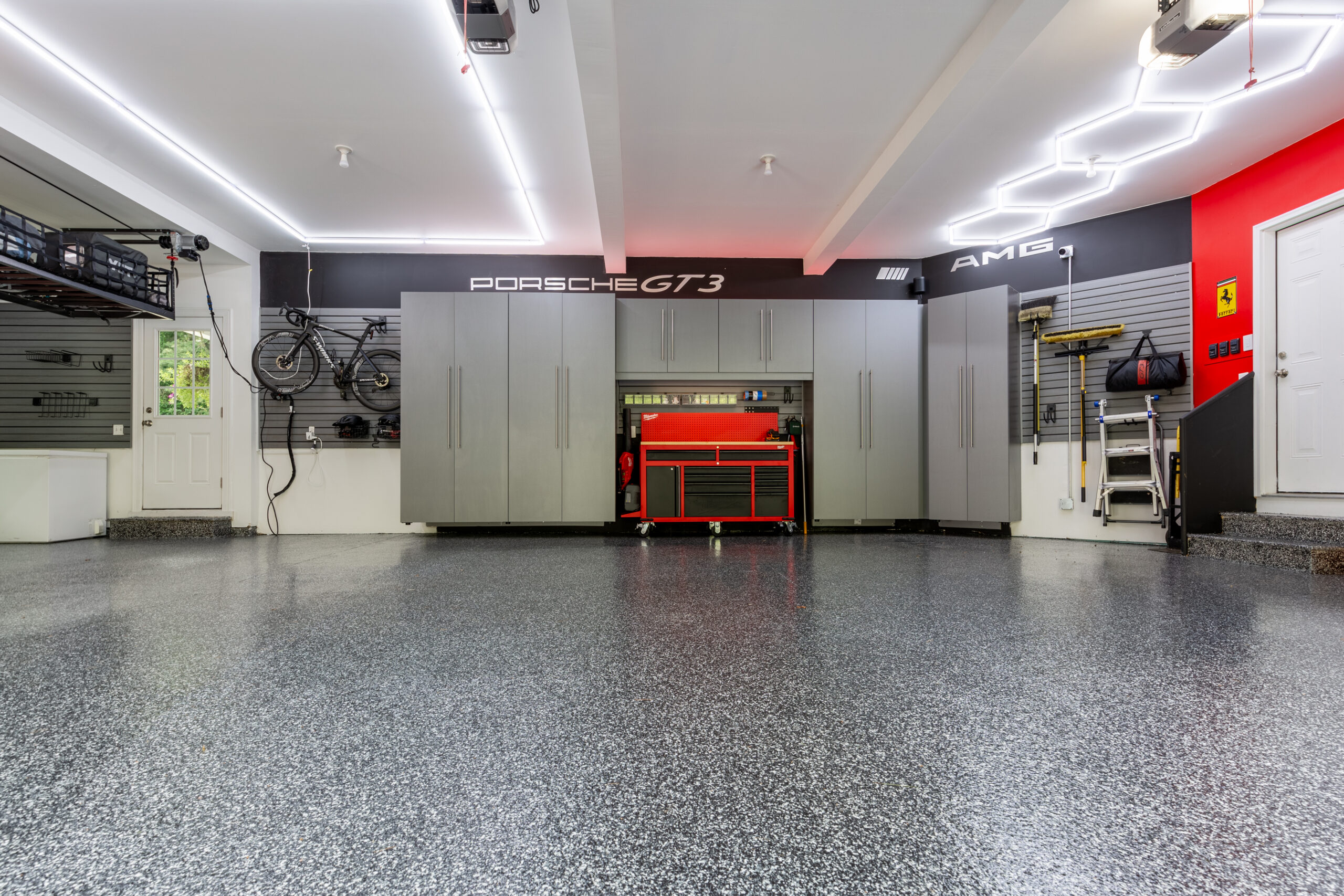 Hybrid epoxy and polyaspartic garage flooring system in a clean, modern residential garage