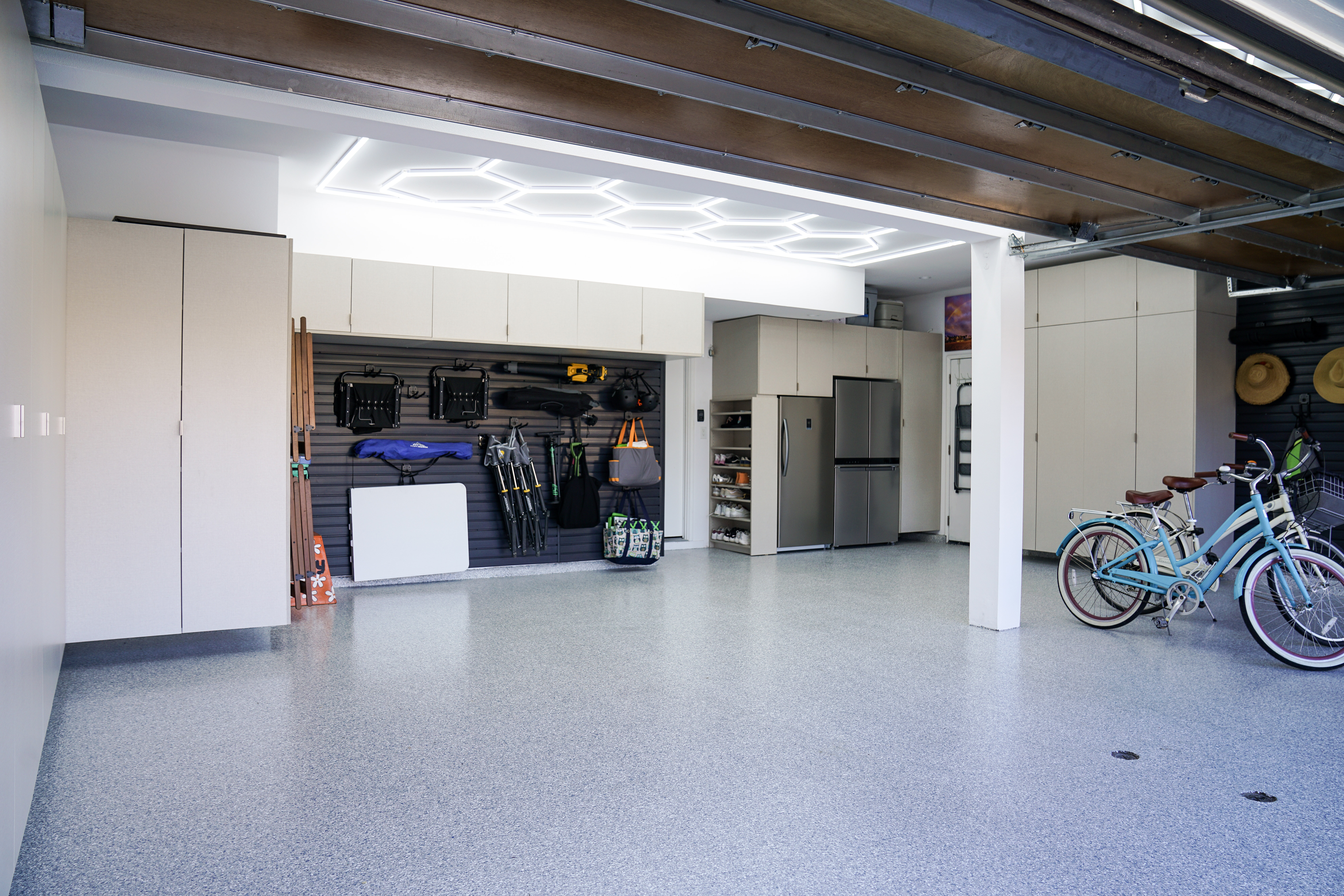 Custom garage cabinet layout with balanced wall storage and open floor space
