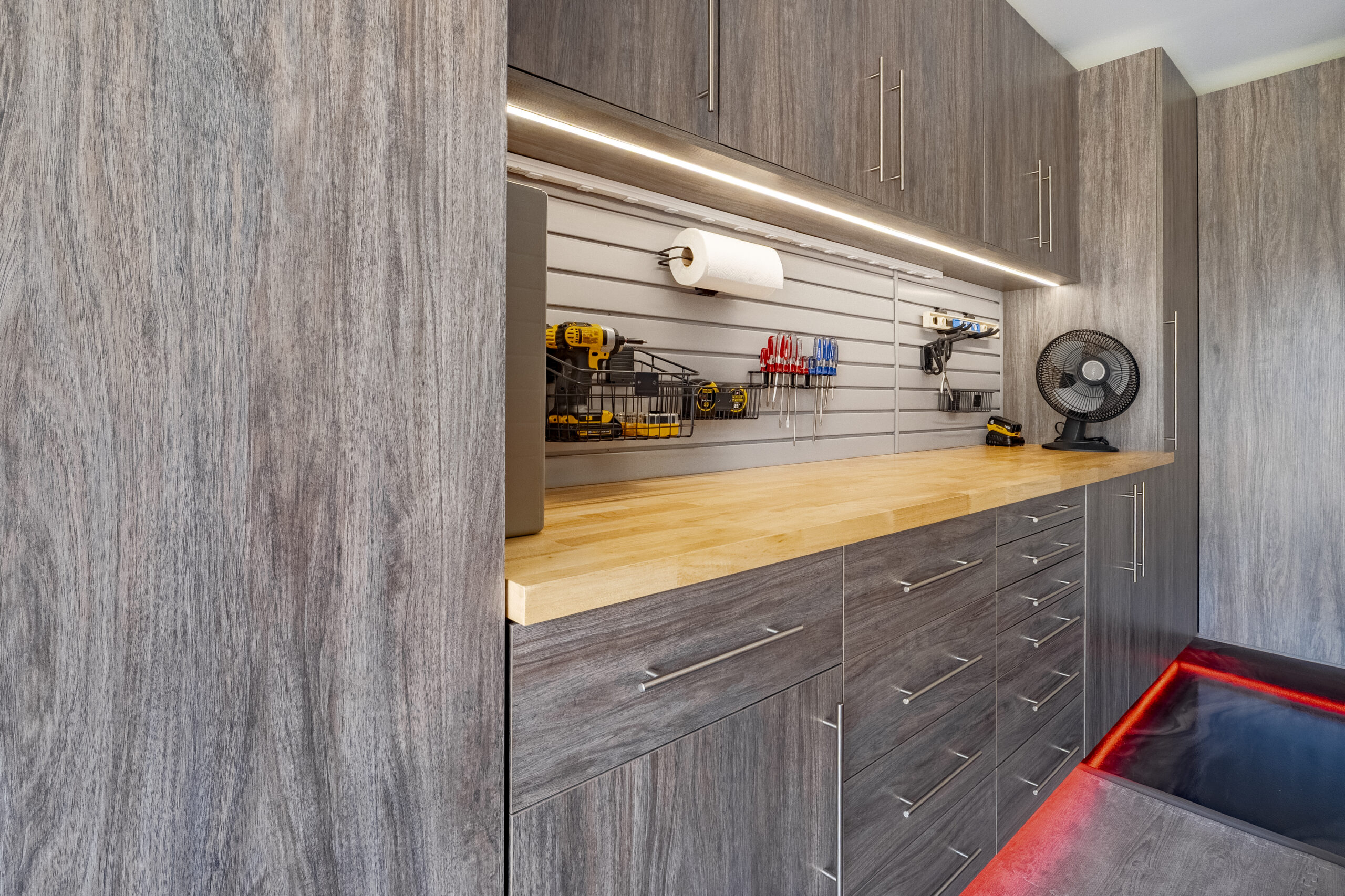 Custom garage cabinets installed wall to wall for a seamless garage storage layout