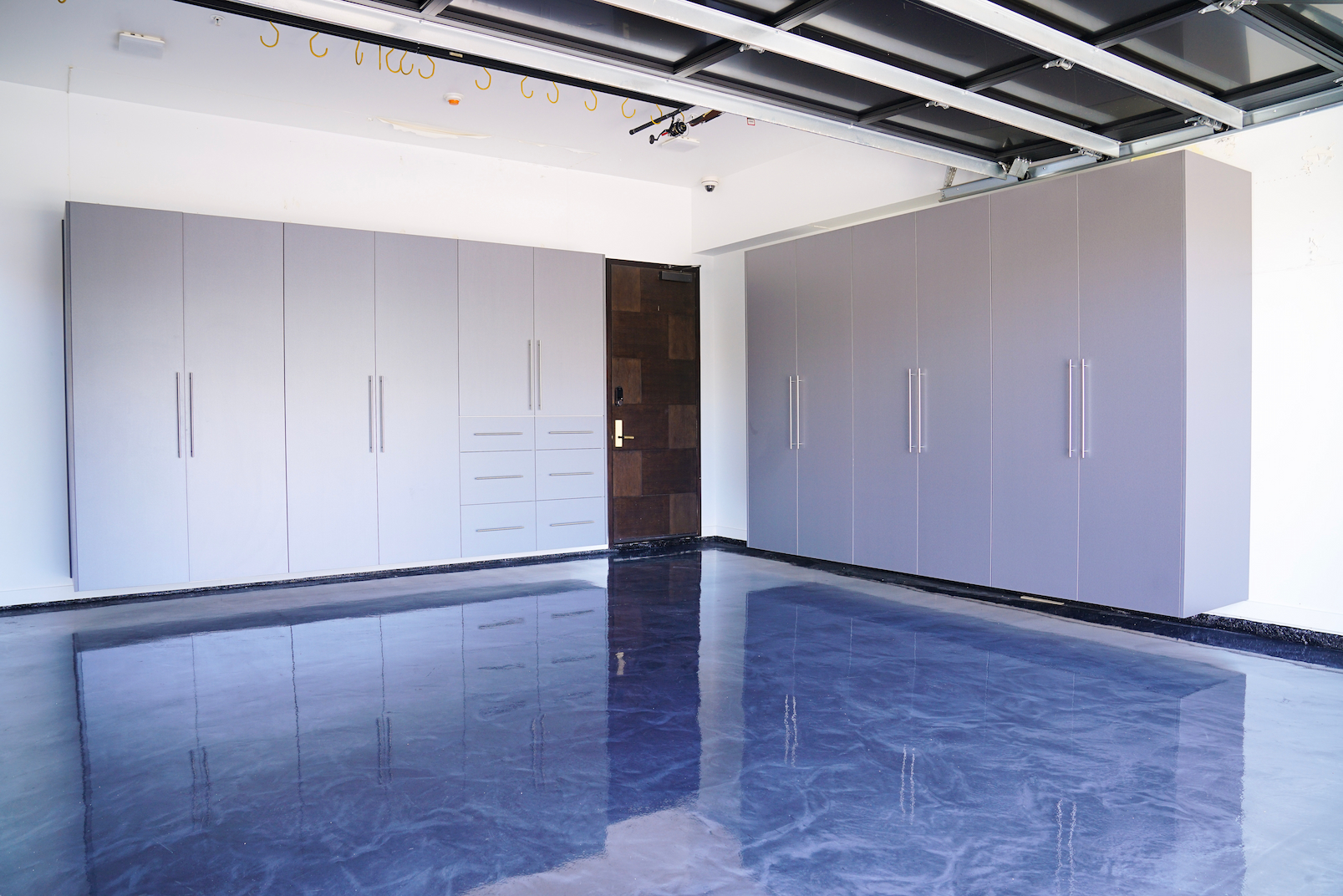 custom premium garage cabinets installed with suspended design and high-gloss garage floor