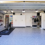 finished custom garage with cabinets storage system and coated garage floor