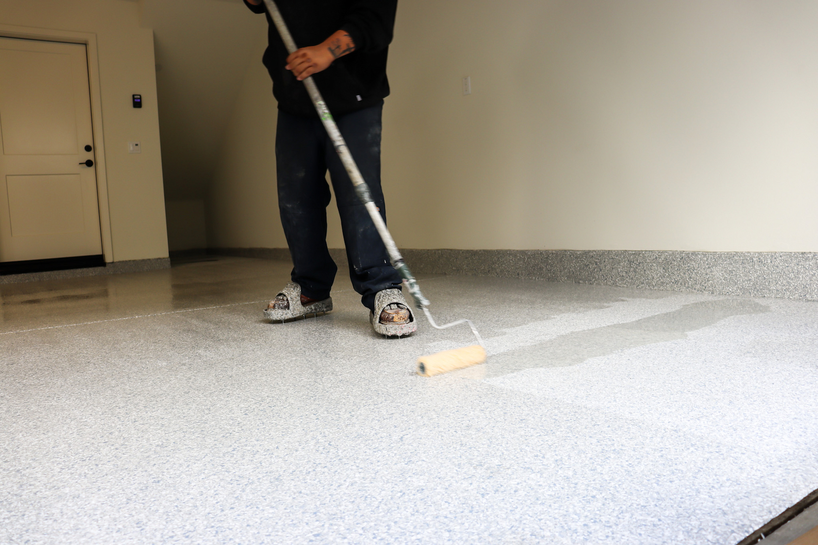 garage floor coating installation using Premier Garage's exclusive system with flake coating