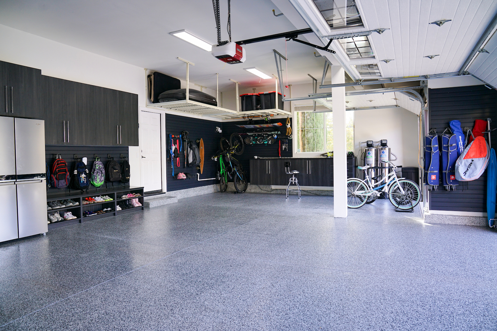 high end garage cabinets with wall storage and coated garage floor in Orange County garage