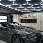 finished garage remodel with custom cabinets wall storage and hex lighting