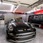 garage lighting design with custom cabinets and car-focused remodel