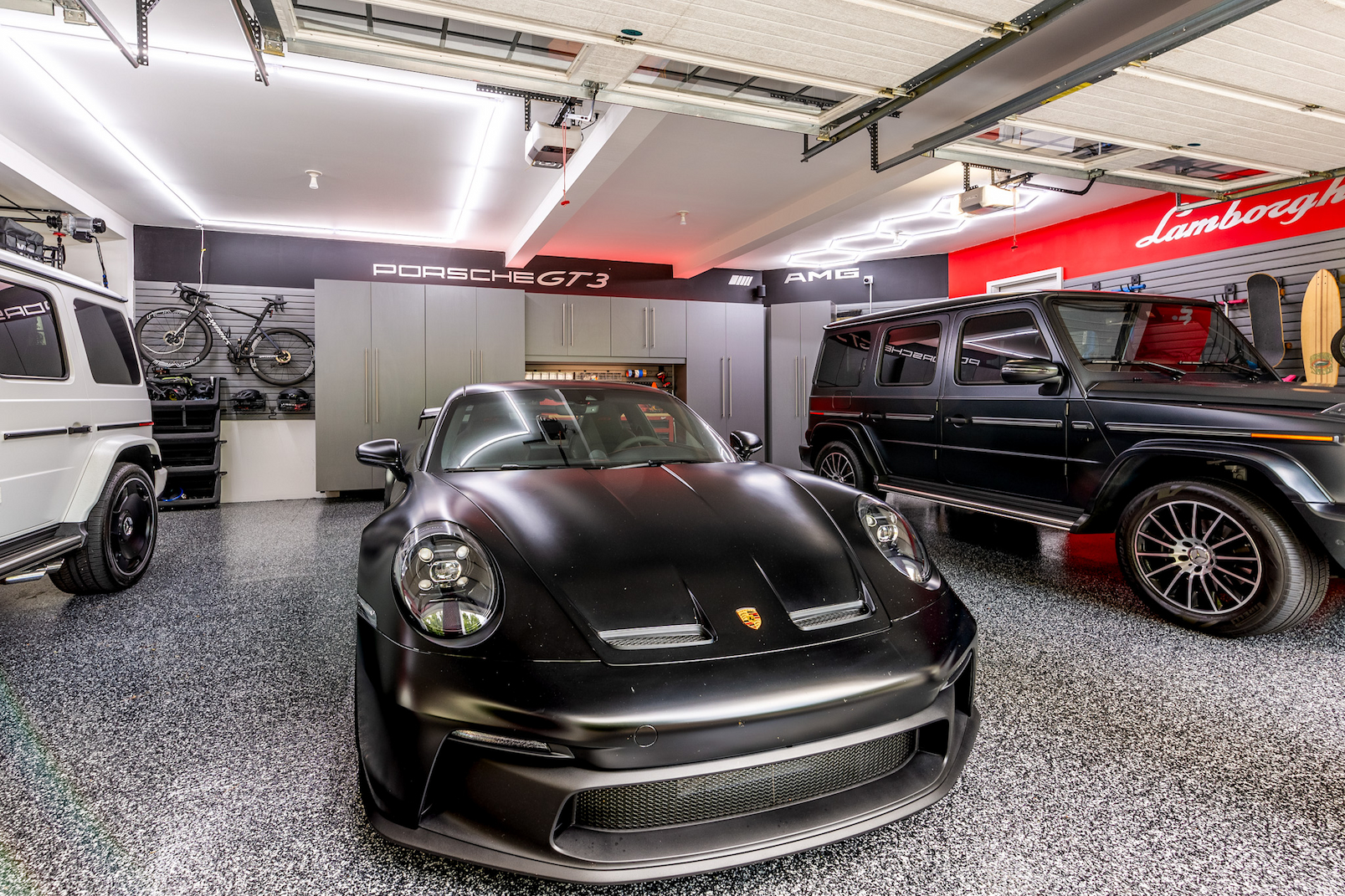 garage lighting design with custom cabinets and car-focused remodel