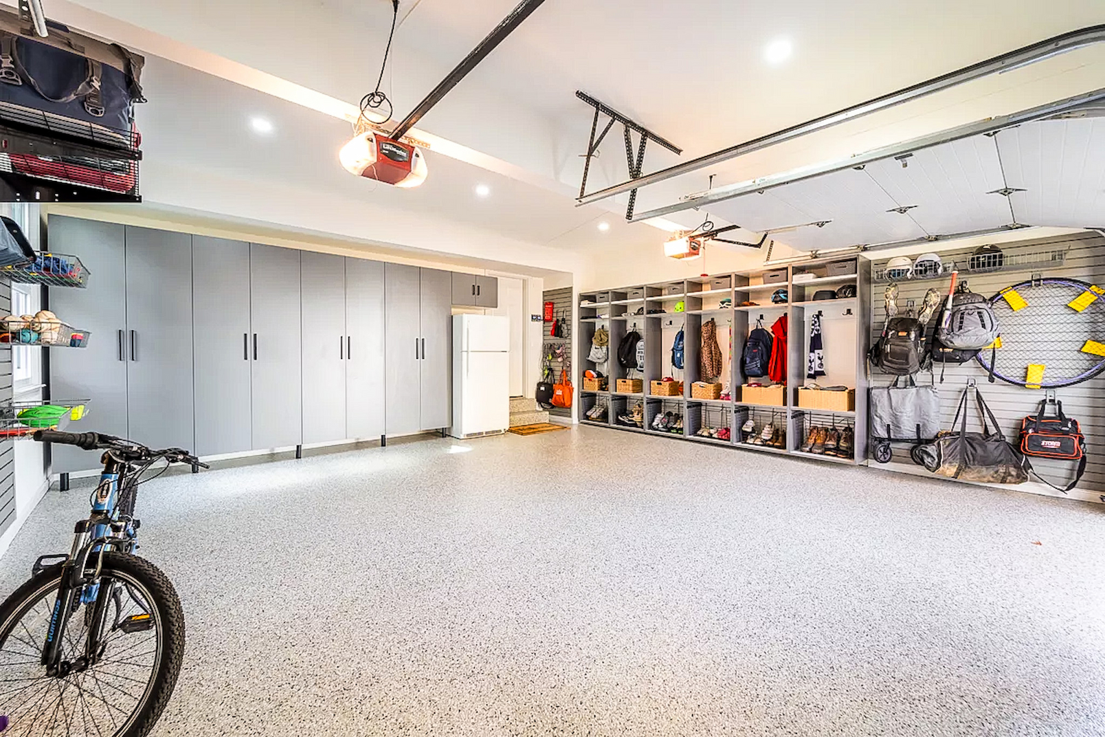custom garage storage system with cabinets and wall storage
