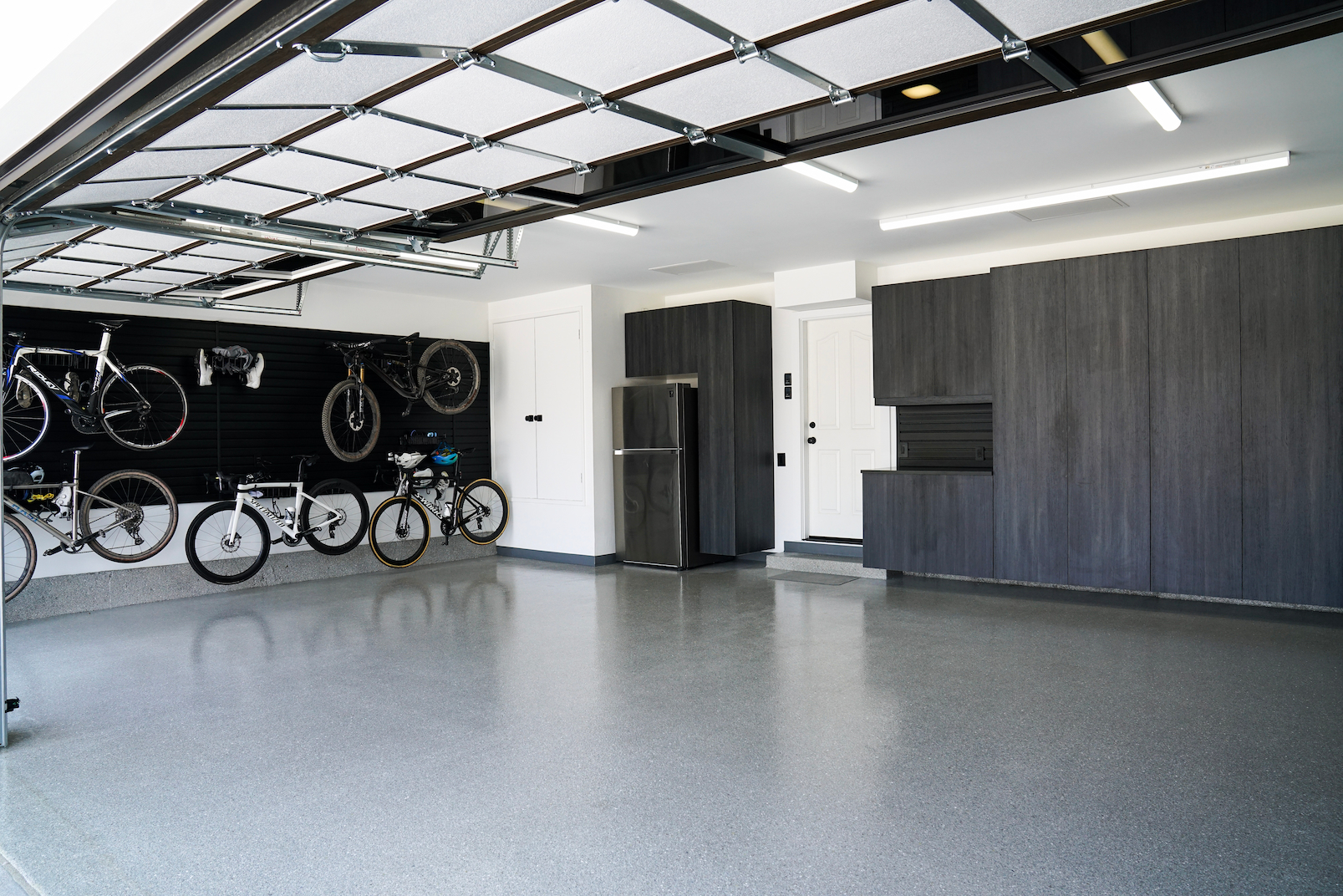 finished garage with wall storage and garage cabinets