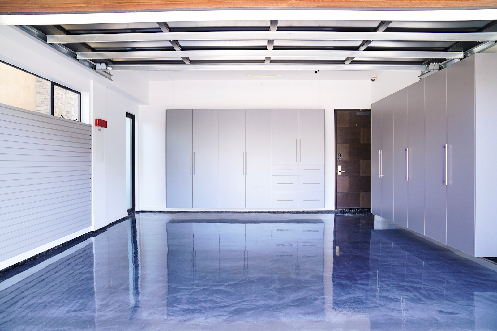 organized garage system with cabinets wall storage and open floor space